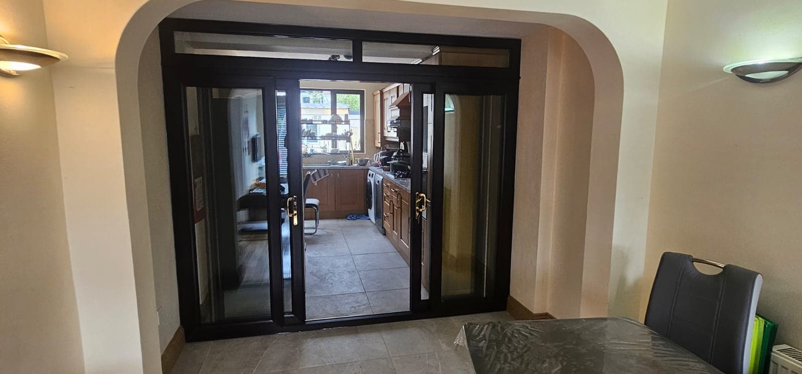 Black aluminium sliding patio doors in a kitchen and dining extension